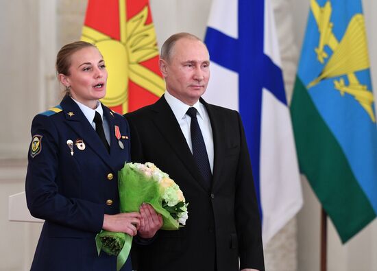 Russian President Vladimir Putin meets with service personnel who took part in counter-terrorism operation in Syria