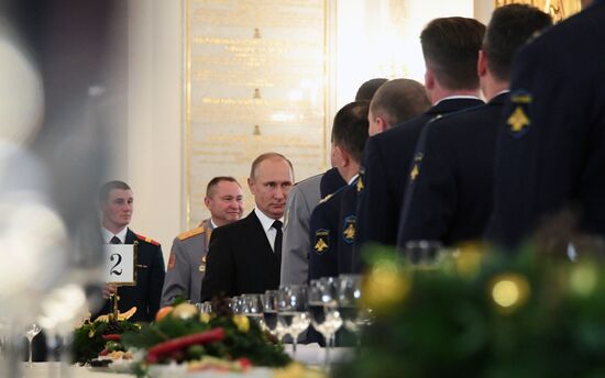 Russian President Vladimir Putin meets with service personnel who took part in counter-terrorism operation in Syria