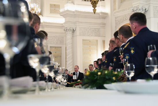 Russian President Vladimir Putin meets with service personnel who took part in counter-terrorism operation in Syria