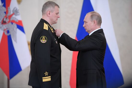 Russian President Vladimir Putin meets with service personnel who took part in counter-terrorism operation in Syria