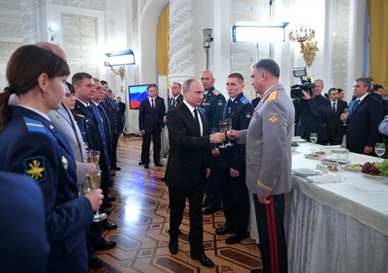 Russian President Vladimir Putin meets with service personnel who took part in counter-terrorism operation in Syria