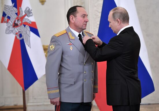 Russian President Vladimir Putin meets with service personnel who took part in counter-terrorism operation in Syria
