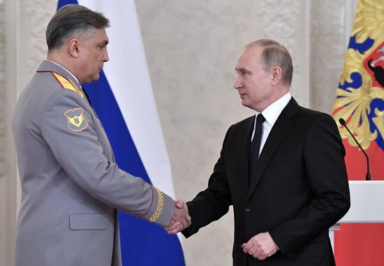 Russian President Vladimir Putin meets with service personnel who took part in counter-terrorism operation in Syria