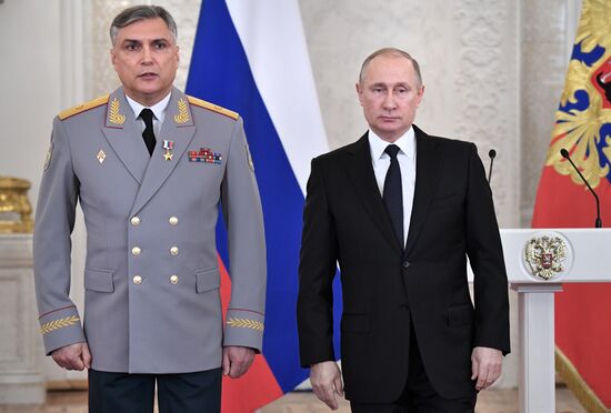 Russian President Vladimir Putin meets with service personnel who took part in counter-terrorism operation in Syria