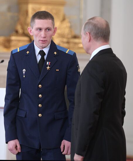 Russian President Vladimir Putin meets with service personnel who took part in counter-terrorism operation in Syria
