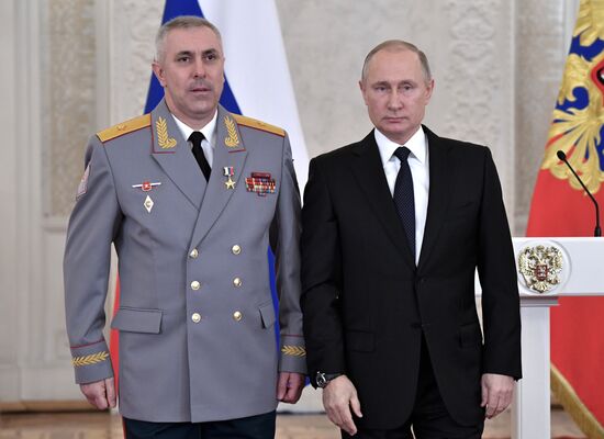 Russian President Vladimir Putin meets with service personnel who took part in counter-terrorism operation in Syria
