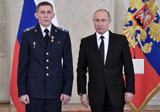 Russian President Vladimir Putin meets with service personnel who took part in counter-terrorism operation in Syria