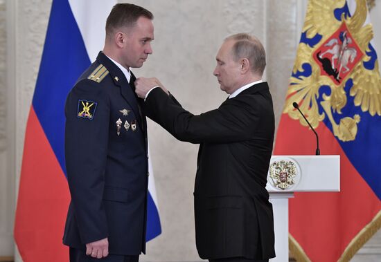 Russian President Vladimir Putin meets with service personnel who took part in counter-terrorism operation in Syria