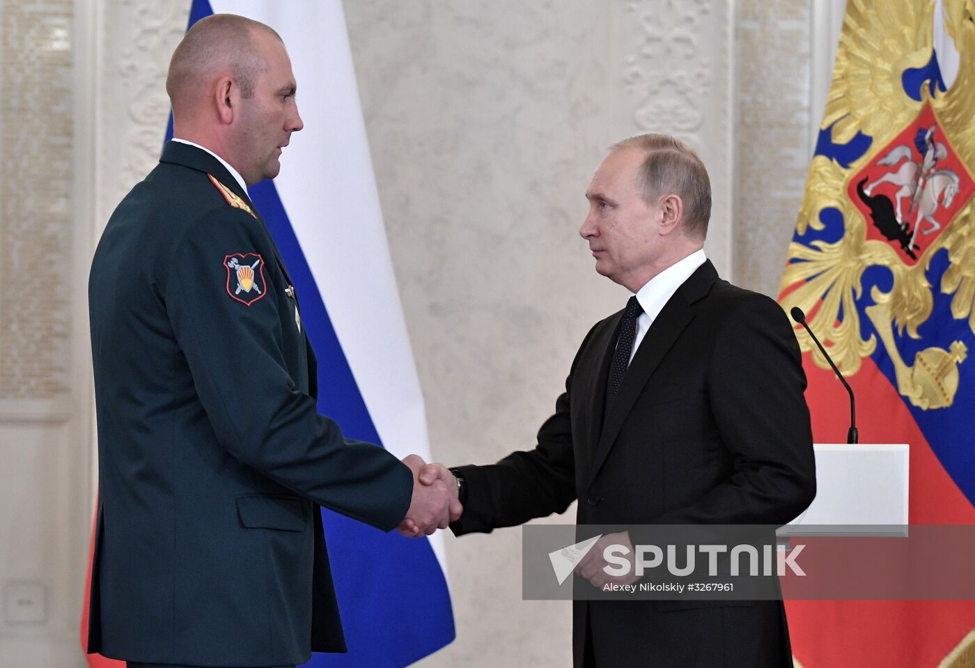 Russian President Vladimir Putin meets with service personnel who took part in counter-terrorism operation in Syria