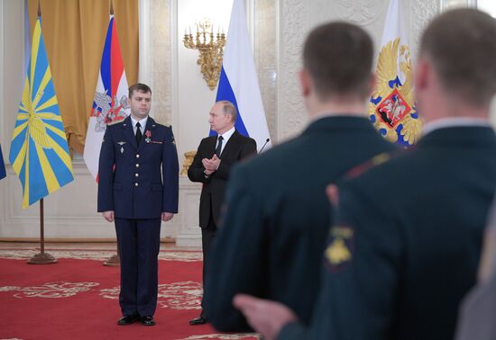 Russian President Vladimir Putin meets with service personnel who took part in counter-terrorism operation in Syria