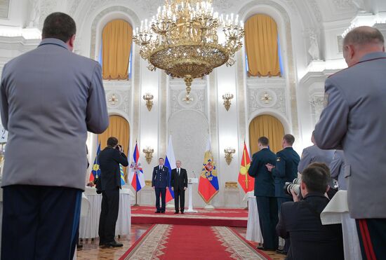 Russian President Vladimir Putin meets with service personnel who took part in counter-terrorism operation in Syria