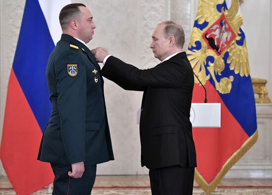 Russian President Vladimir Putin meets with service personnel who took part in counter-terrorism operation in Syria