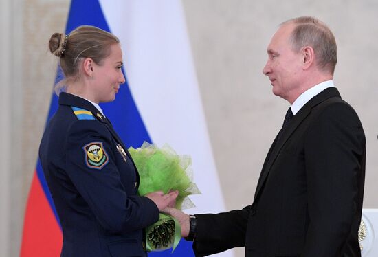 Russian President Vladimir Putin meets with service personnel who took part in counter-terrorism operation in Syria