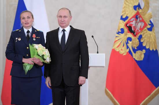 Russian President Vladimir Putin meets with service personnel who took part in counter-terrorism operation in Syria