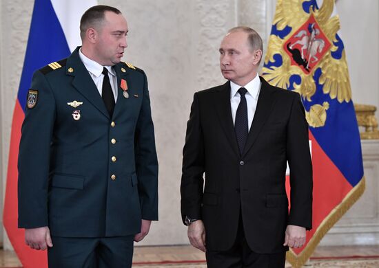 Russian President Vladimir Putin meets with service personnel who took part in counter-terrorism operation in Syria