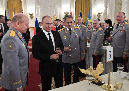 Russian President Vladimir Putin meets with service personnel who took part in counter-terrorism operation in Syria