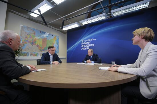 President Vladimir Putin visits his campaign headquarters in Moscow