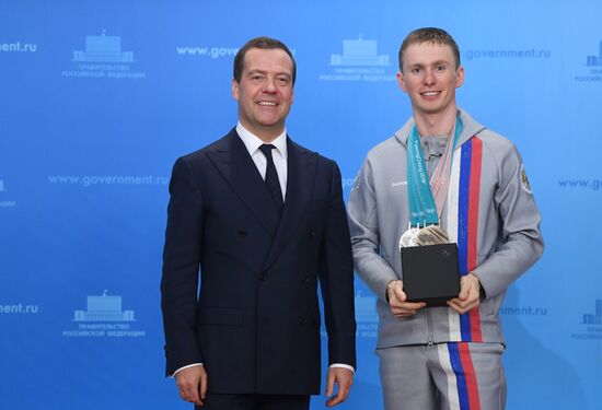 Prime Minister Dmitry Medvedev presents cars to 2018 Winter Olympics medalists at ceremony