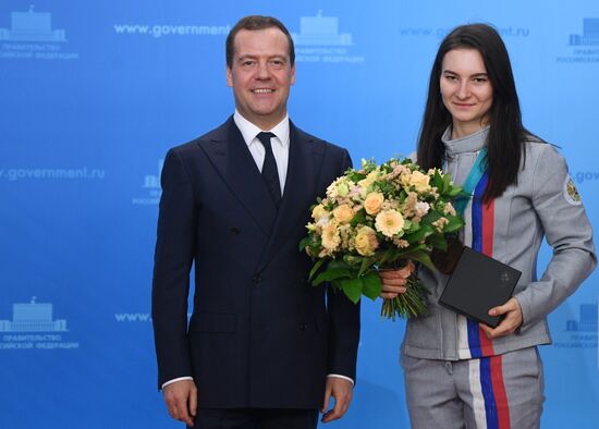 Prime Minister Dmitry Medvedev presents cars to 2018 Winter Olympics medalists at ceremony