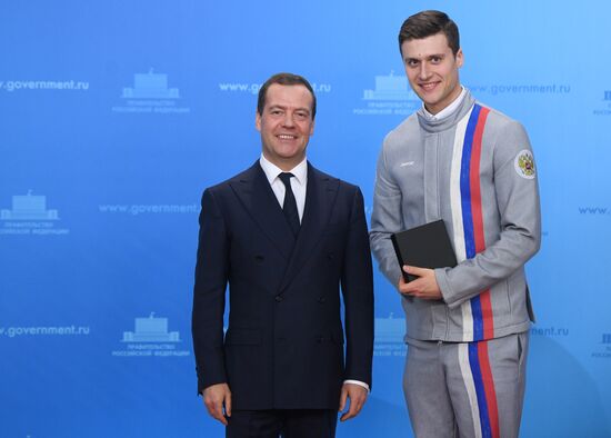 Prime Minister Dmitry Medvedev presents cars to 2018 Winter Olympics medalists at ceremony