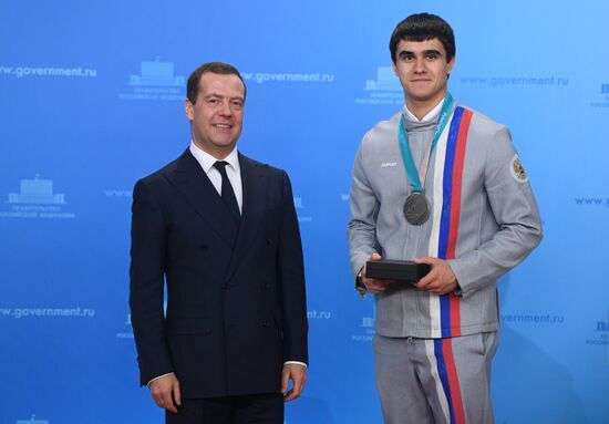 Prime Minister Dmitry Medvedev presents cars to 2018 Winter Olympics medalists at ceremony