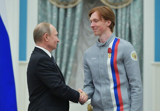 President Vladimir Putin presents state decorations to 2018 Winter Olympics medalists