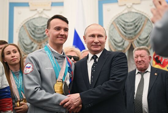 Russian President Vladimir Putin meets with Russian athletes - winners and medalists of 12th Paralympic Winter Games