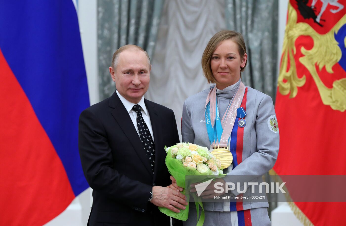 Russian President Vladimir Putin meets with Russian athletes - winners and medalists of 12th Paralympic Winter Games