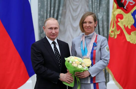 Russian President Vladimir Putin meets with Russian athletes - winners and medalists of 12th Paralympic Winter Games