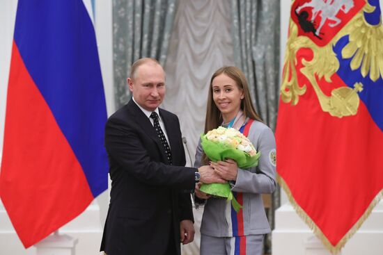 Russian President Vladimir Putin meets with Russian athletes - winners and medalists of 12th Paralympic Winter Games