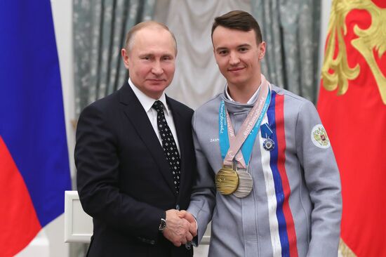 Russian President Vladimir Putin meets with Russian athletes - winners and medalists of 12th Paralympic Winter Games