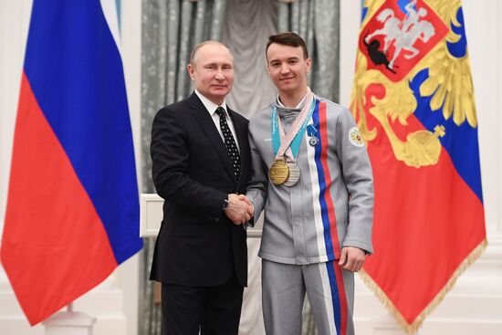 Russian President Vladimir Putin meets with Russian athletes - winners and medalists of 12th Paralympic Winter Games