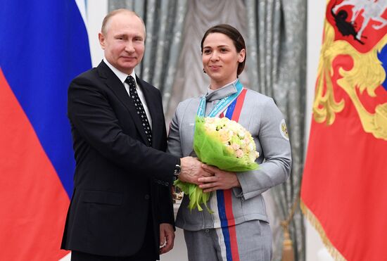 Russian President Vladimir Putin meets with Russian athletes - winners and medalists of 12th Paralympic Winter Games