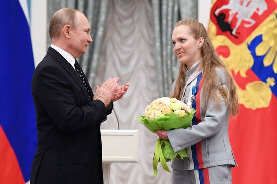 Russian President Vladimir Putin meets with Russian athletes - winners and medalists of 12th Paralympic Winter Games