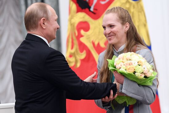 Russian President Vladimir Putin meets with Russian athletes - winners and medalists of 12th Paralympic Winter Games