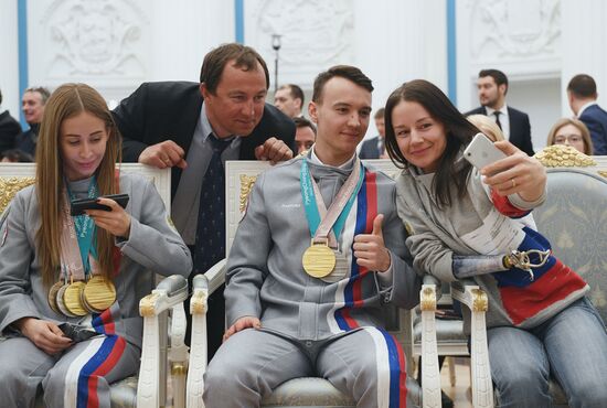 Russian President Vladimir Putin meets with Russian athletes - winners and medalists of 12th Paralympic Winter Games
