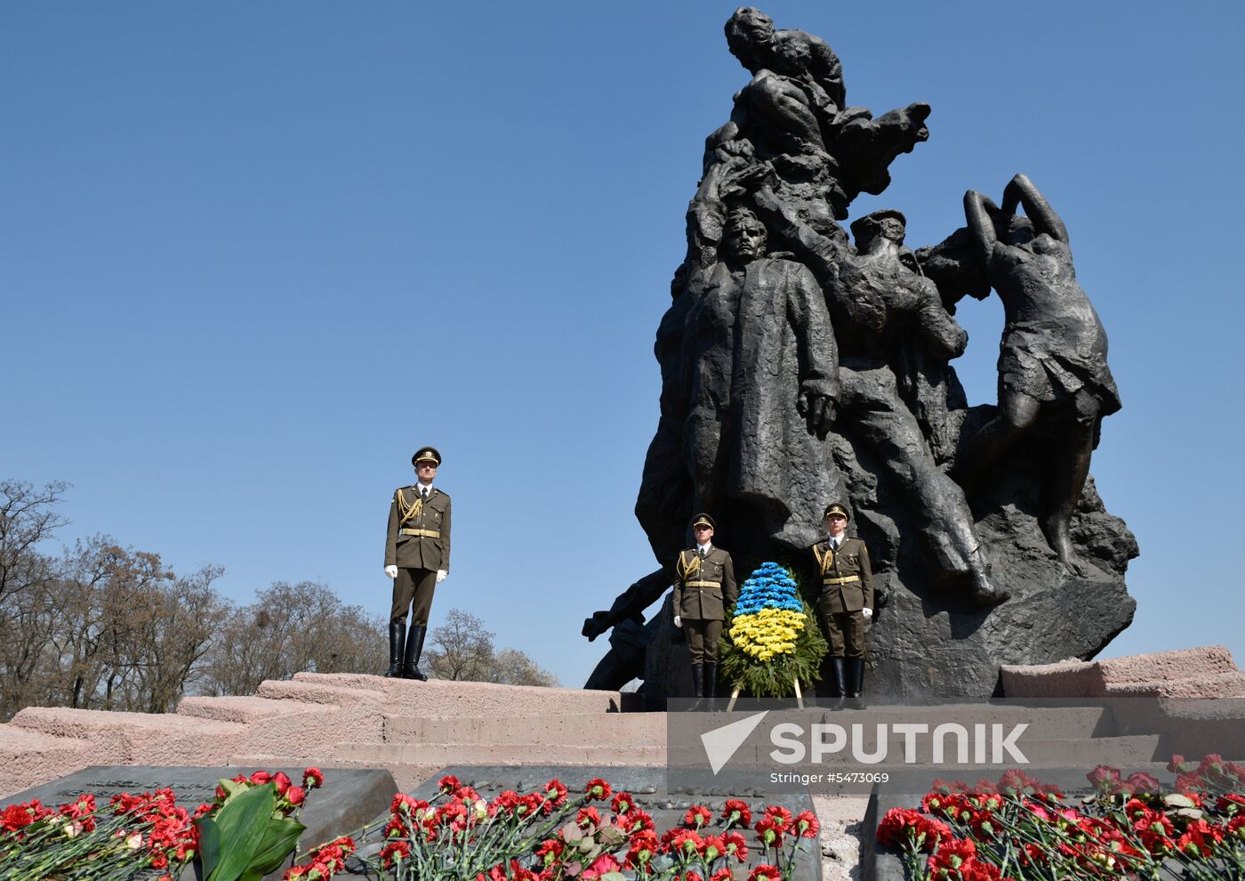 Laying flowers at Babiy Yar massacre memorial