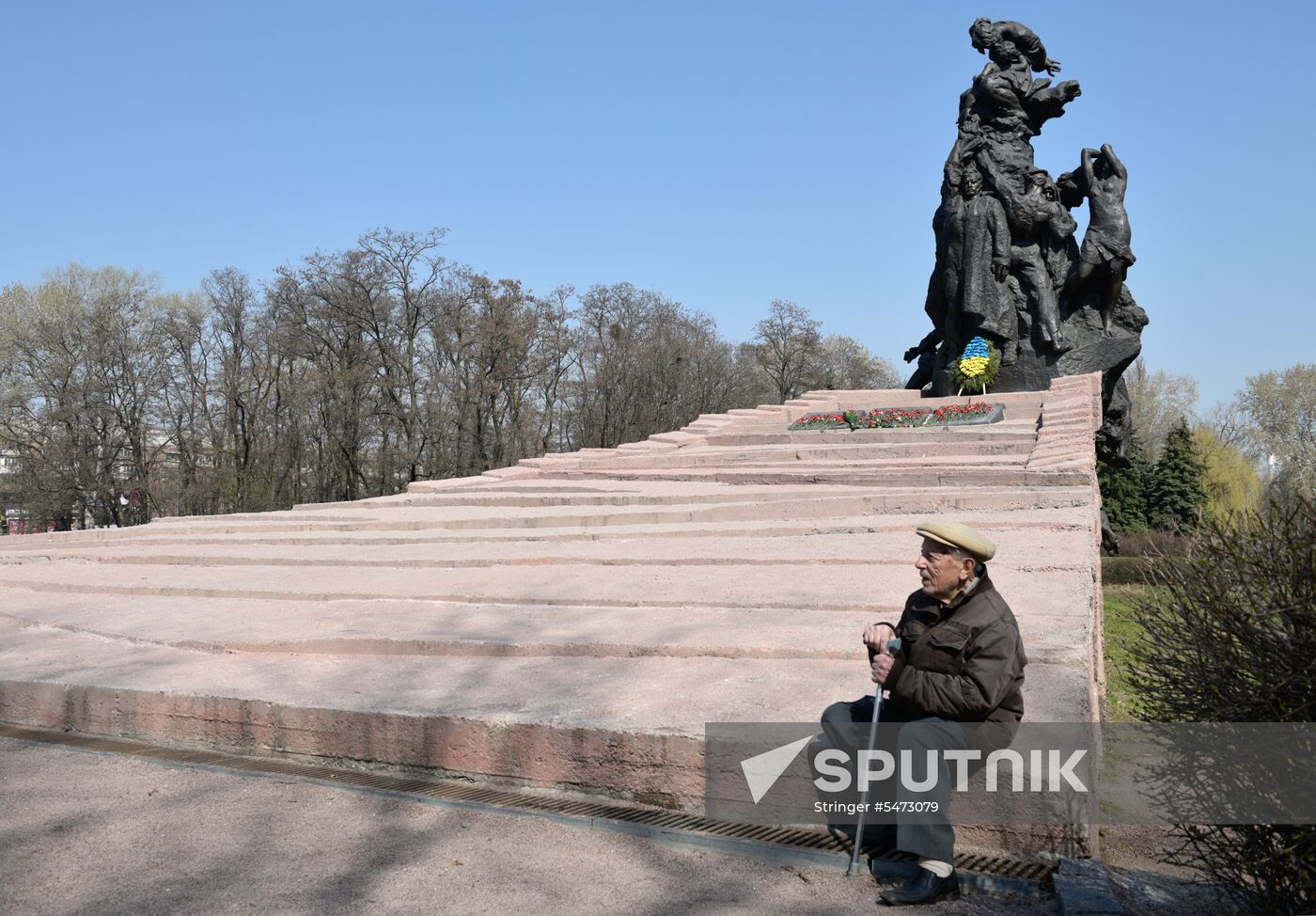 Laying flowers at Babiy Yar massacre memorial