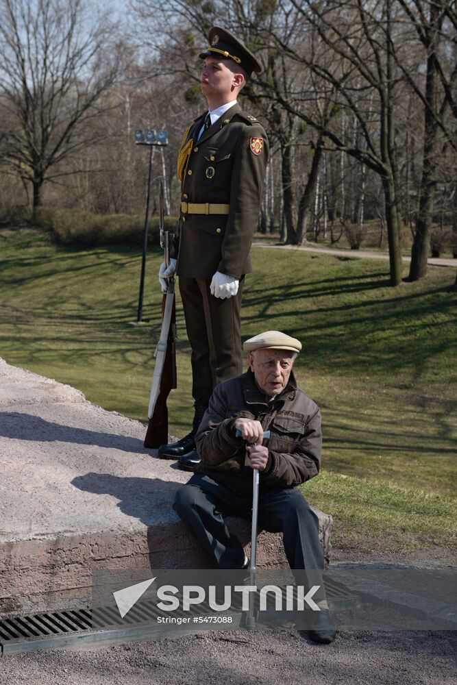 Laying flowers at Babiy Yar massacre memorial