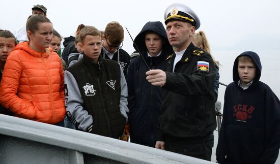 Handing children's letters over to Russian mariners aboard Varyag missile cruiser