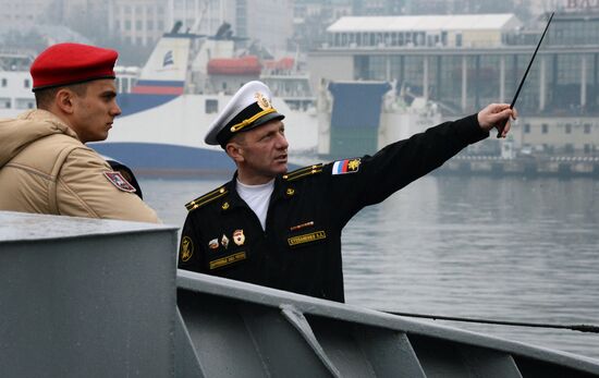 Handing children's letters over to Russian mariners aboard Varyag missile cruiser