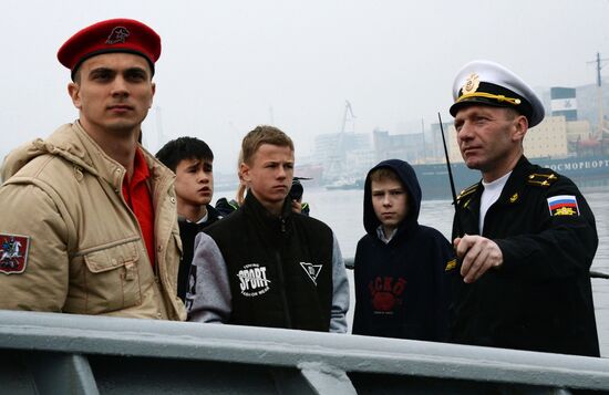 Handing children's letters over to Russian mariners aboard Varyag missile cruiser