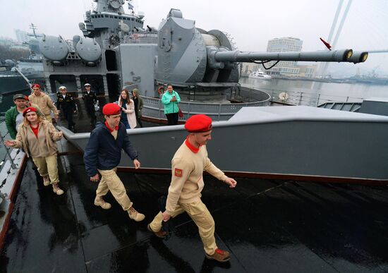 Handing children's letters over to Russian mariners aboard Varyag missile cruiser