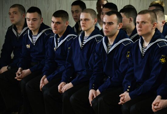 Handing children's letters over to Russian mariners aboard Varyag missile cruiser