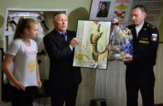 Handing children's letters over to Russian mariners aboard Varyag missile cruiser