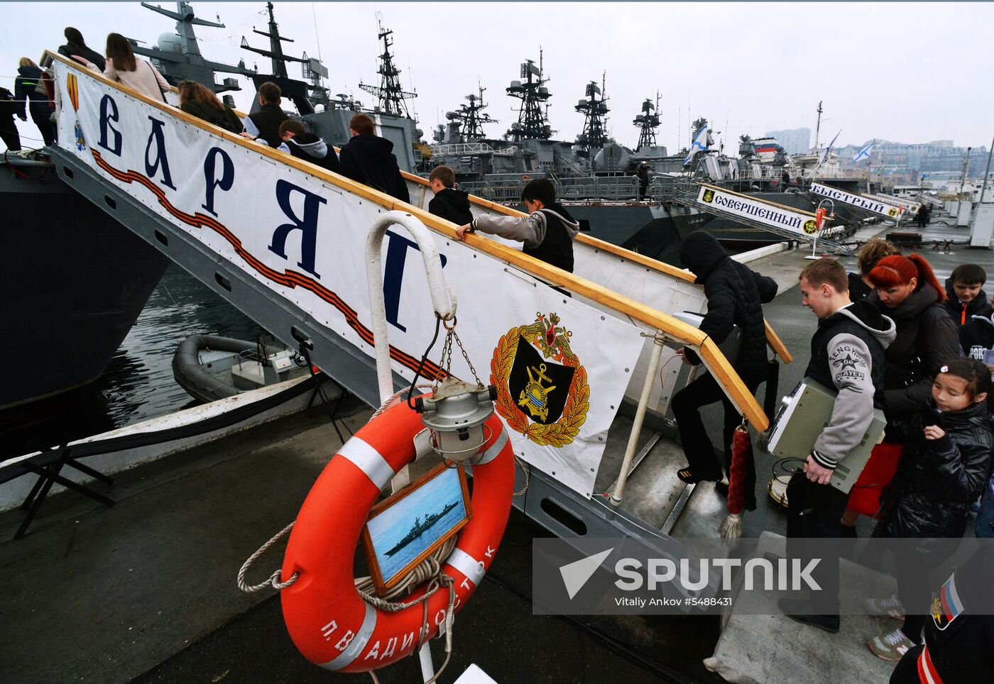 Handing children's letters over to Russian mariners aboard Varyag missile cruiser