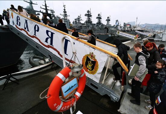 Handing children's letters over to Russian mariners aboard Varyag missile cruiser