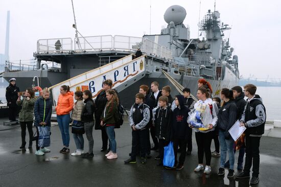 Handing children's letters over to Russian mariners aboard Varyag missile cruiser