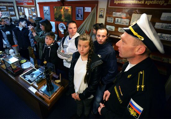 Handing children's letters over to Russian mariners aboard Varyag missile cruiser