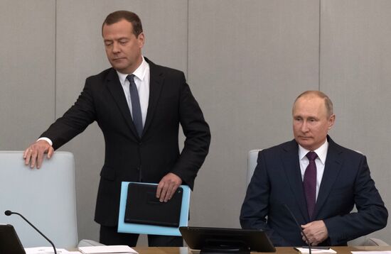 Russian President Vladimir Putin and candidate for Prime Minister Dmitry Medvedev attend State Duma plenary meeting